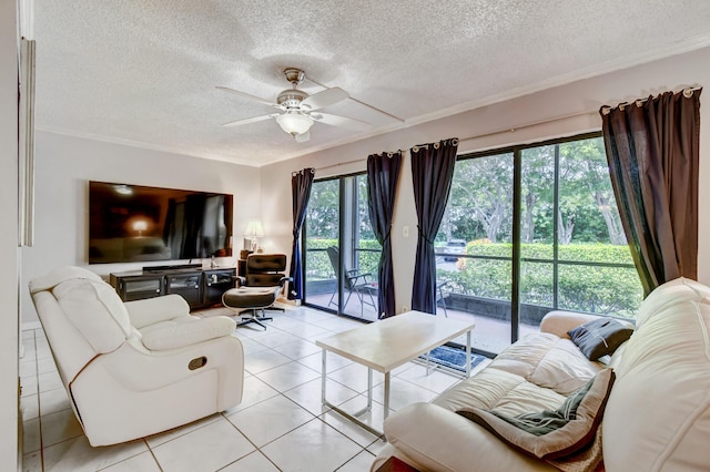 living room featuring light tile patterned floors, a textured ceiling, ceiling fan, and a healthy amount of sunlight