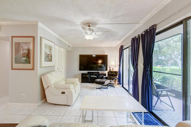 living room featuring a textured ceiling, ceiling fan, crown molding, and light tile patterned flooring