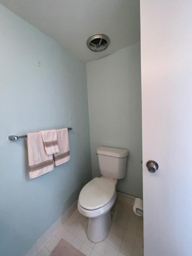 bathroom with tile flooring and toilet