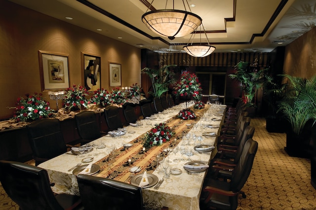 dining room featuring dark carpet and a tray ceiling