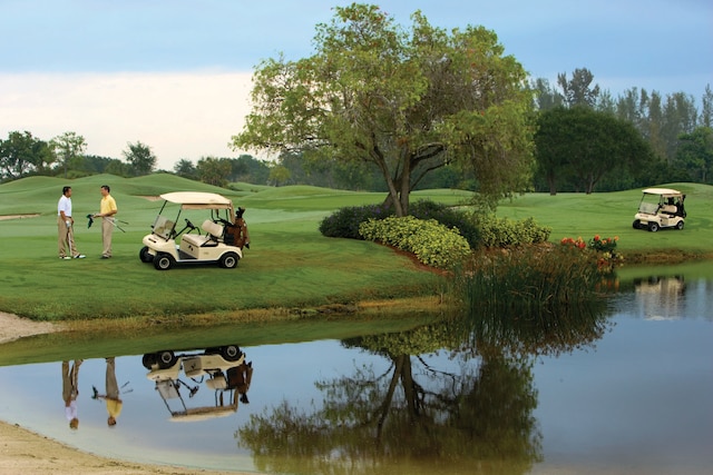 view of property's community with a yard and a water view