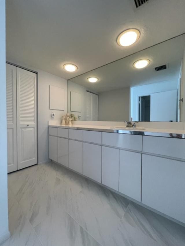 interior space with dual vanity and tile flooring