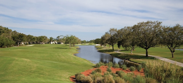 surrounding community with a yard and a water view