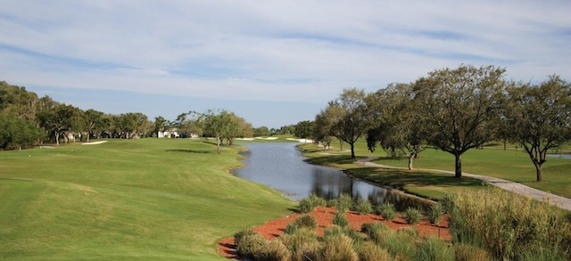 view of home's community featuring a lawn and a water view