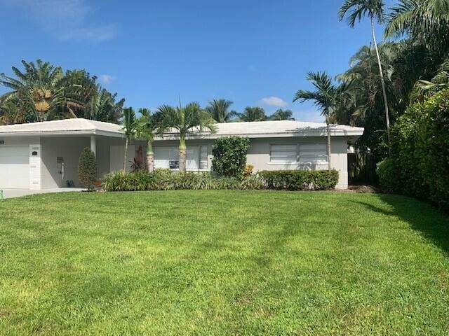 view of front of property with a front lawn and a garage