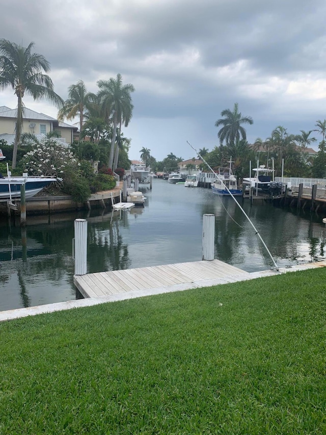 dock area featuring a water view and a yard