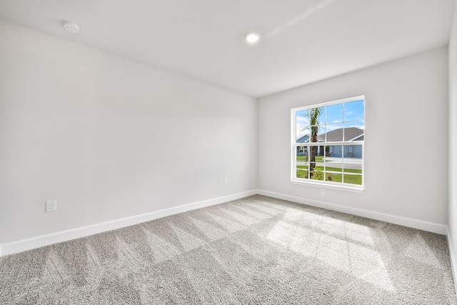 unfurnished room with light carpet