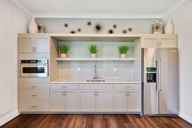 kitchen featuring backsplash, dark hardwood / wood-style floors, appliances with stainless steel finishes, sink, and crown molding