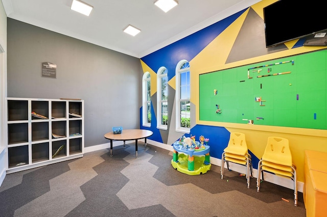 recreation room with dark colored carpet