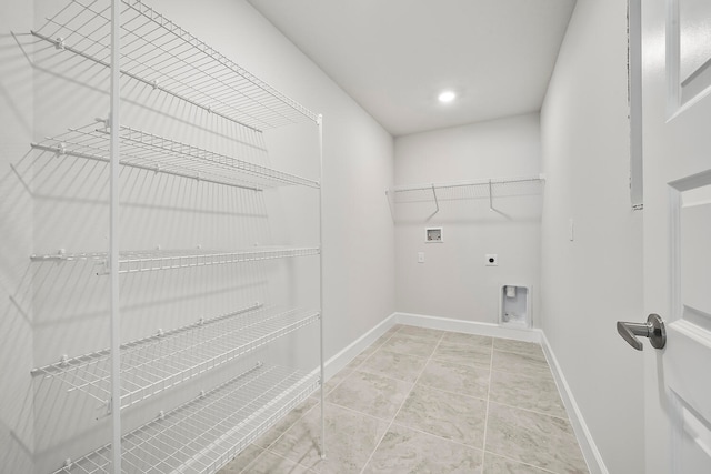 clothes washing area featuring hookup for a washing machine, electric dryer hookup, and light tile floors