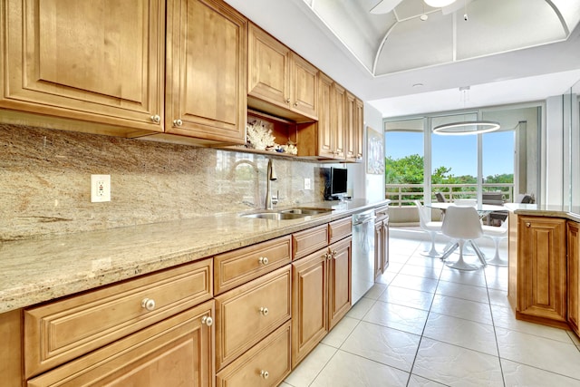 kitchen featuring backsplash, light stone countertops, ceiling fan, stainless steel dishwasher, and sink