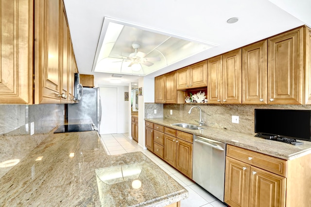 kitchen featuring light stone counters, light tile patterned flooring, sink, stainless steel appliances, and ceiling fan