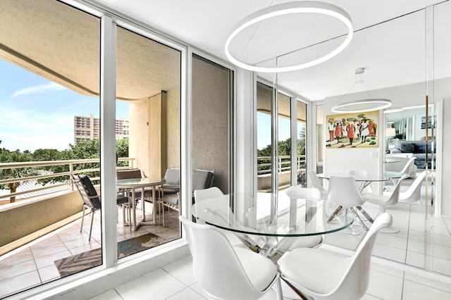 tiled dining space featuring a wall of windows