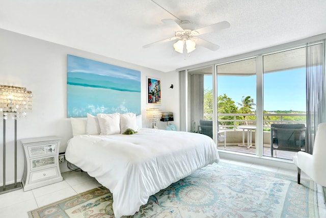 tiled bedroom featuring ceiling fan, access to exterior, and a textured ceiling