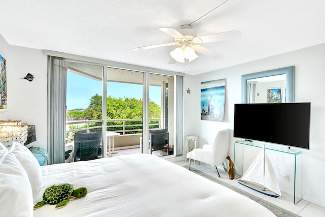 tiled bedroom with ceiling fan, access to outside, and a textured ceiling