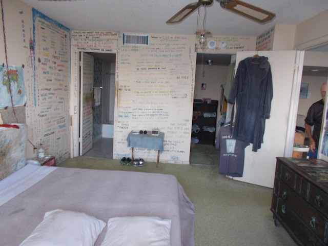 carpeted bedroom featuring ensuite bath and ceiling fan