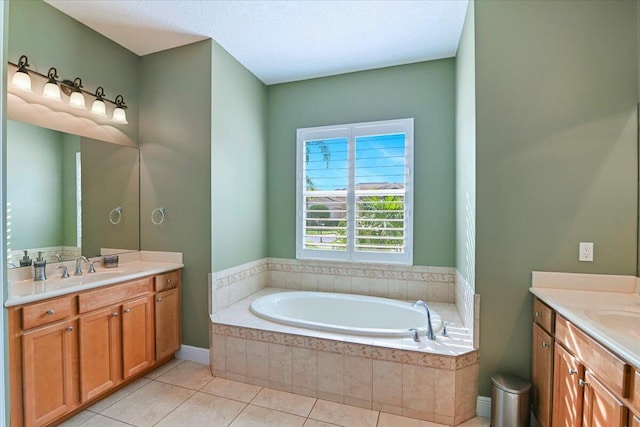 bathroom featuring vanity, a relaxing tiled tub, and tile patterned floors