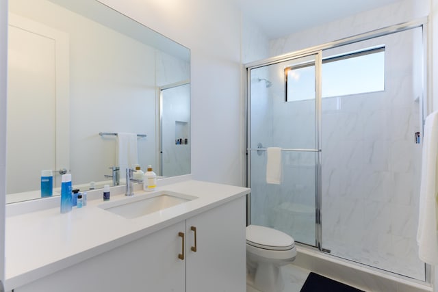 bathroom with vanity, toilet, and walk in shower