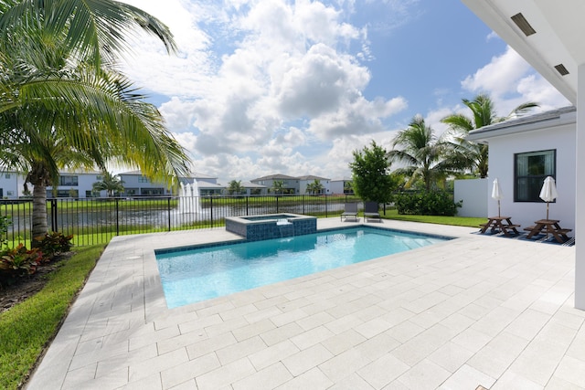 view of swimming pool with a patio area, an in ground hot tub, and a water view