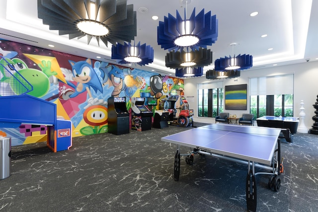 playroom with a raised ceiling