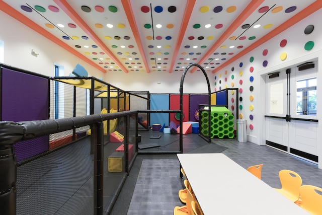 playroom with beam ceiling