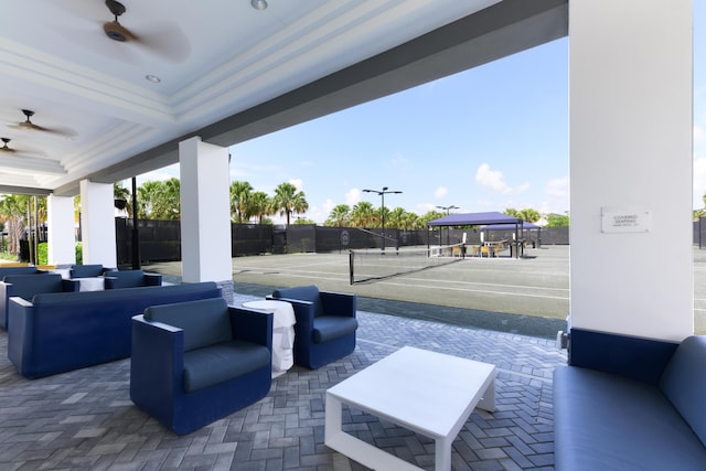 view of patio / terrace with tennis court, ceiling fan, and an outdoor living space