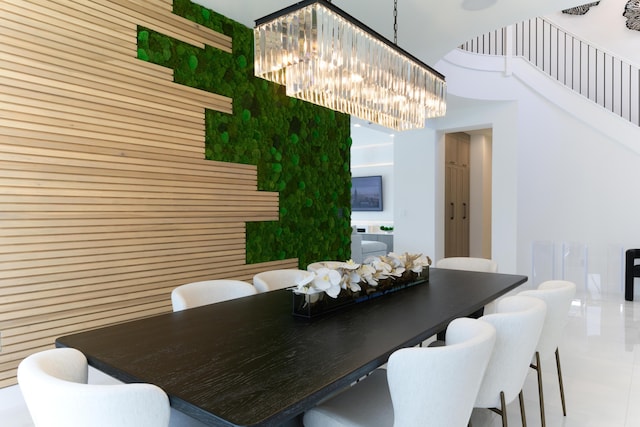 dining area with a high ceiling and a notable chandelier