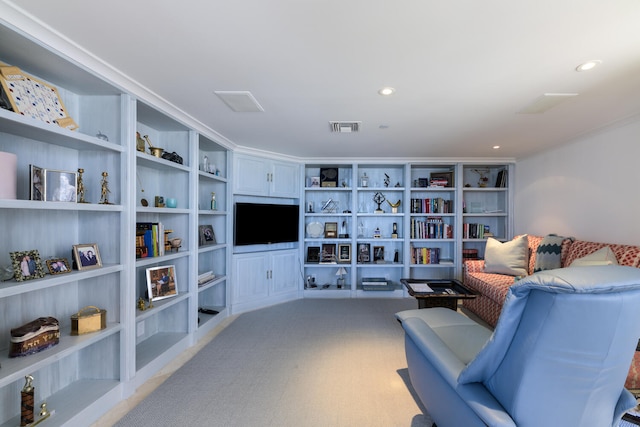 living area featuring built in shelves and carpet flooring