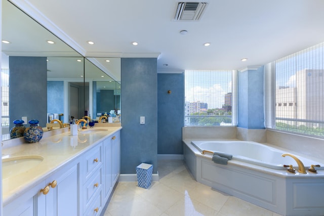 bathroom featuring vanity, crown molding, a bathtub, and tile patterned flooring