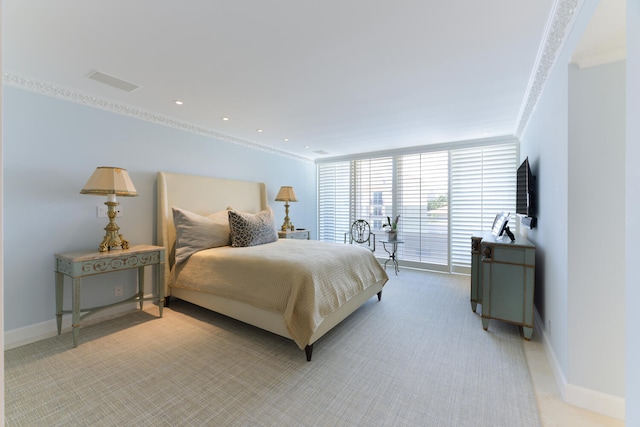 bedroom featuring crown molding, light colored carpet, and access to exterior