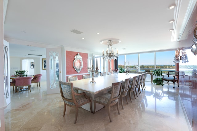 dining area with crown molding, a wall of windows, and a notable chandelier