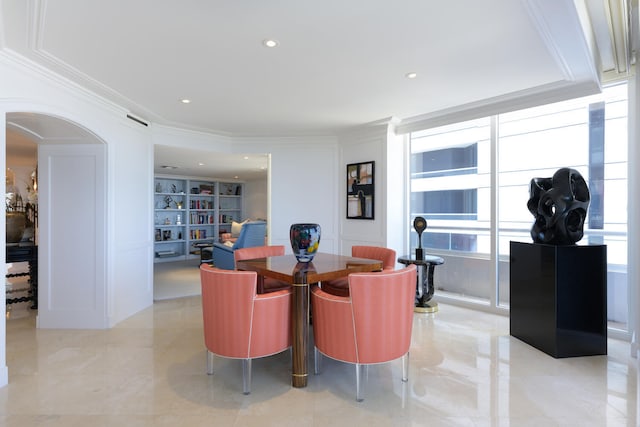 dining space with ornamental molding