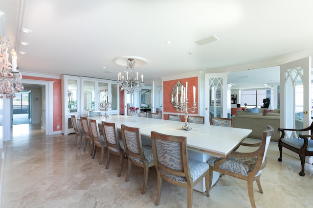 dining space featuring ornamental molding and a notable chandelier