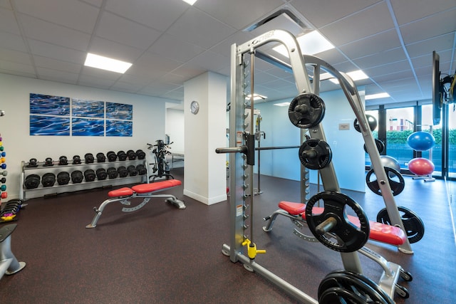 exercise room featuring a drop ceiling