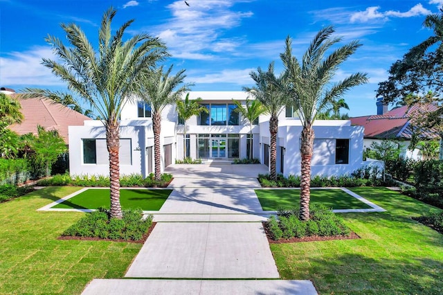 view of front facade with a garage and a front yard