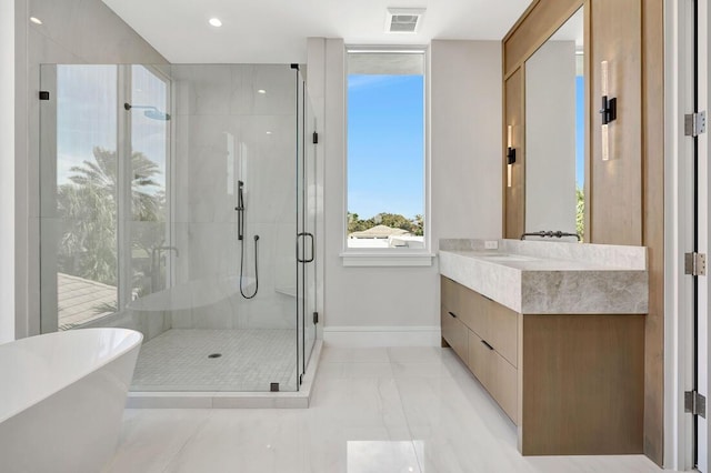 bathroom featuring vanity and separate shower and tub