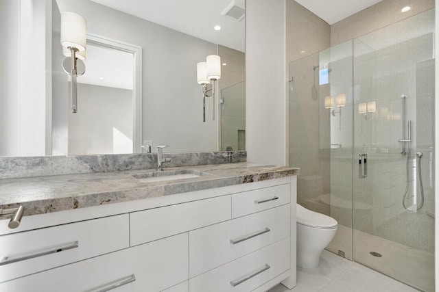 bathroom featuring tile patterned flooring, vanity, toilet, and a shower with shower door