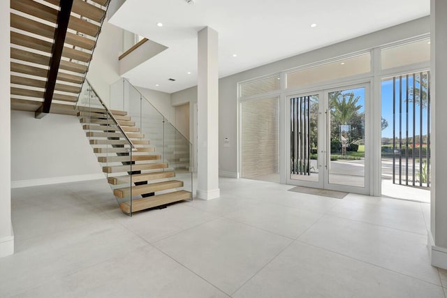 stairway featuring french doors and concrete floors