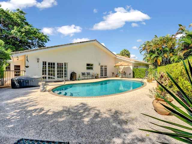 view of pool with a patio area and french doors