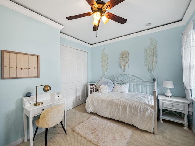 carpeted bedroom with a closet, ornamental molding, and ceiling fan