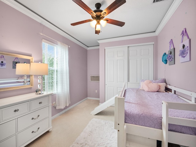 carpeted bedroom with crown molding, a closet, and ceiling fan