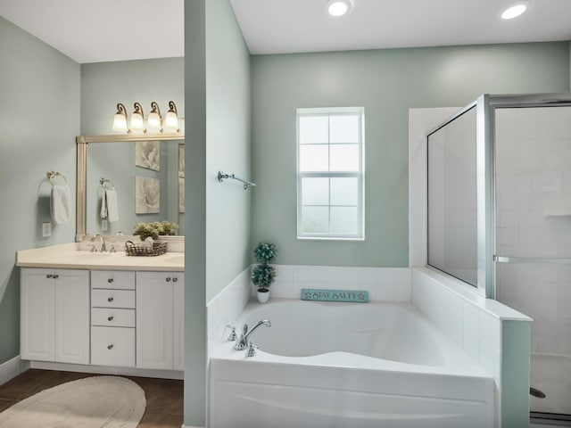 bathroom featuring vanity and shower with separate bathtub