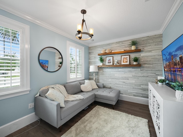 living room featuring crown molding, dark hardwood / wood-style floors, and an inviting chandelier