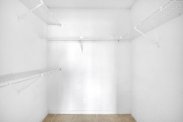 spacious closet featuring light tile floors