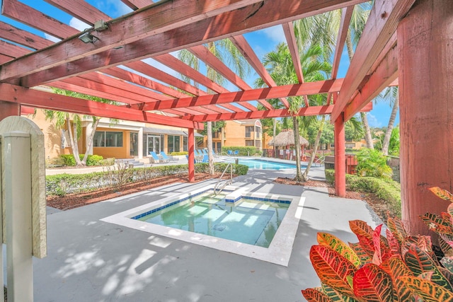 view of pool featuring a pergola, a patio area, and an in ground hot tub