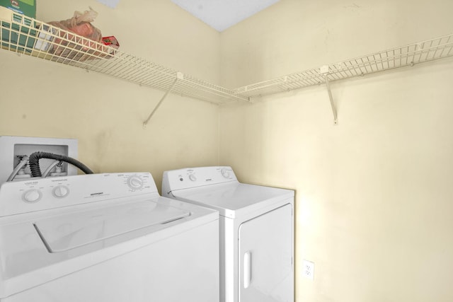 clothes washing area featuring hookup for a washing machine and washing machine and dryer