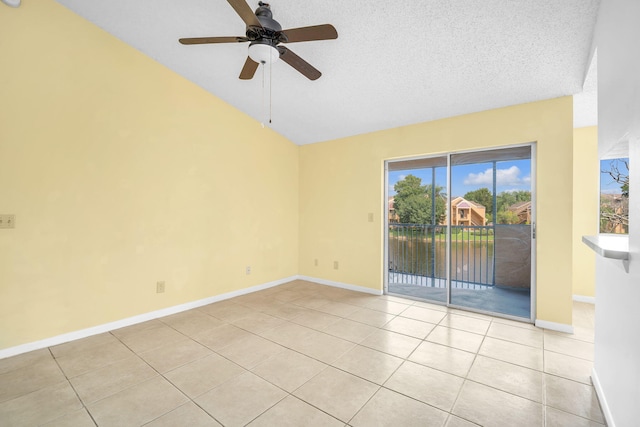 tiled spare room with vaulted ceiling, ceiling fan, and a textured ceiling