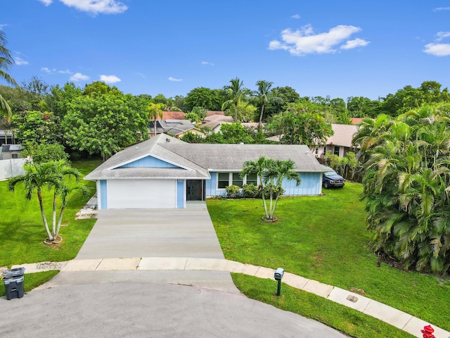 single story home featuring a garage and a front lawn