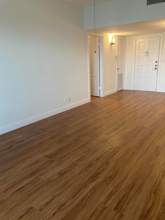 empty room featuring dark wood-type flooring