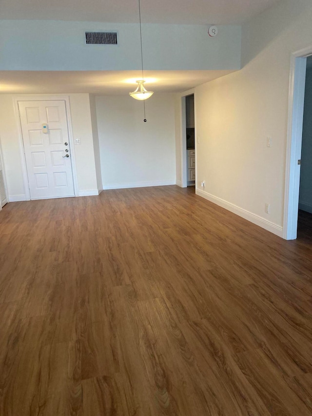 spare room featuring dark hardwood / wood-style flooring